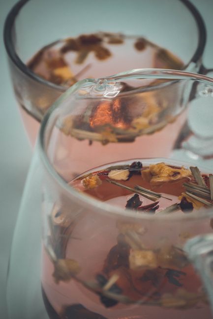 High angle of crystal transparent cups filled with aromatic herbal tea for teatime