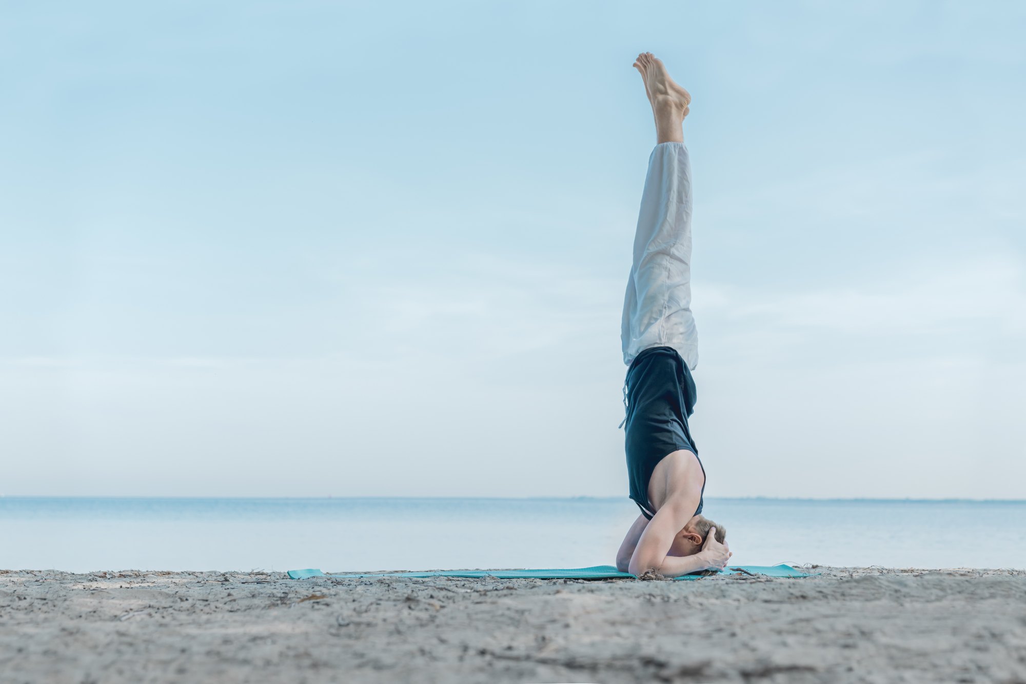 Headstand on a quiet beach