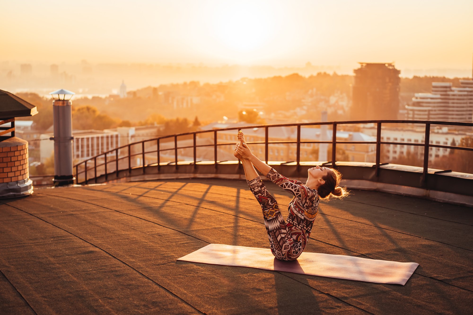 Morning yoga on a rooftop terrace at sunrise