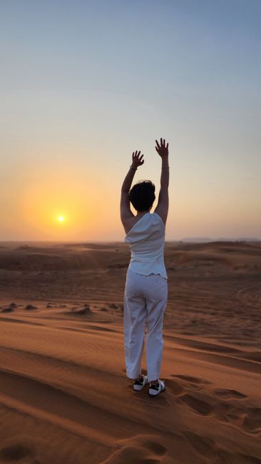 A person in a yoga pose at sunset in a vast desert, evoking calm and balance